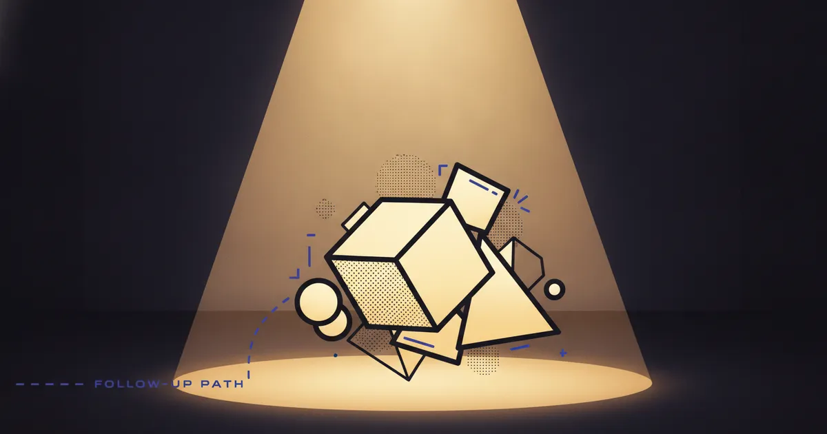 geometric forms in a warm spotlight pool on a dark stage