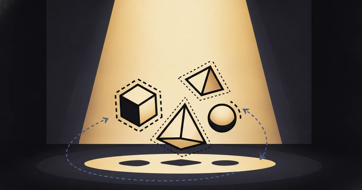 geometric forms in a warm spotlight pool on a dark stage